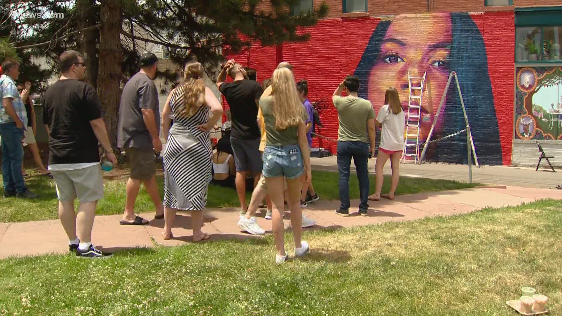 Family and friends gathered to watch a mural of Isabella Thallas be ...