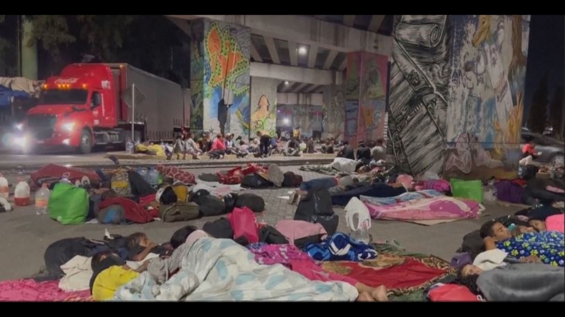 Families with young children sleeping on top of cardboard boxes and young men and women tucked away in tents under a nearby bridge scrambled to pack their things.