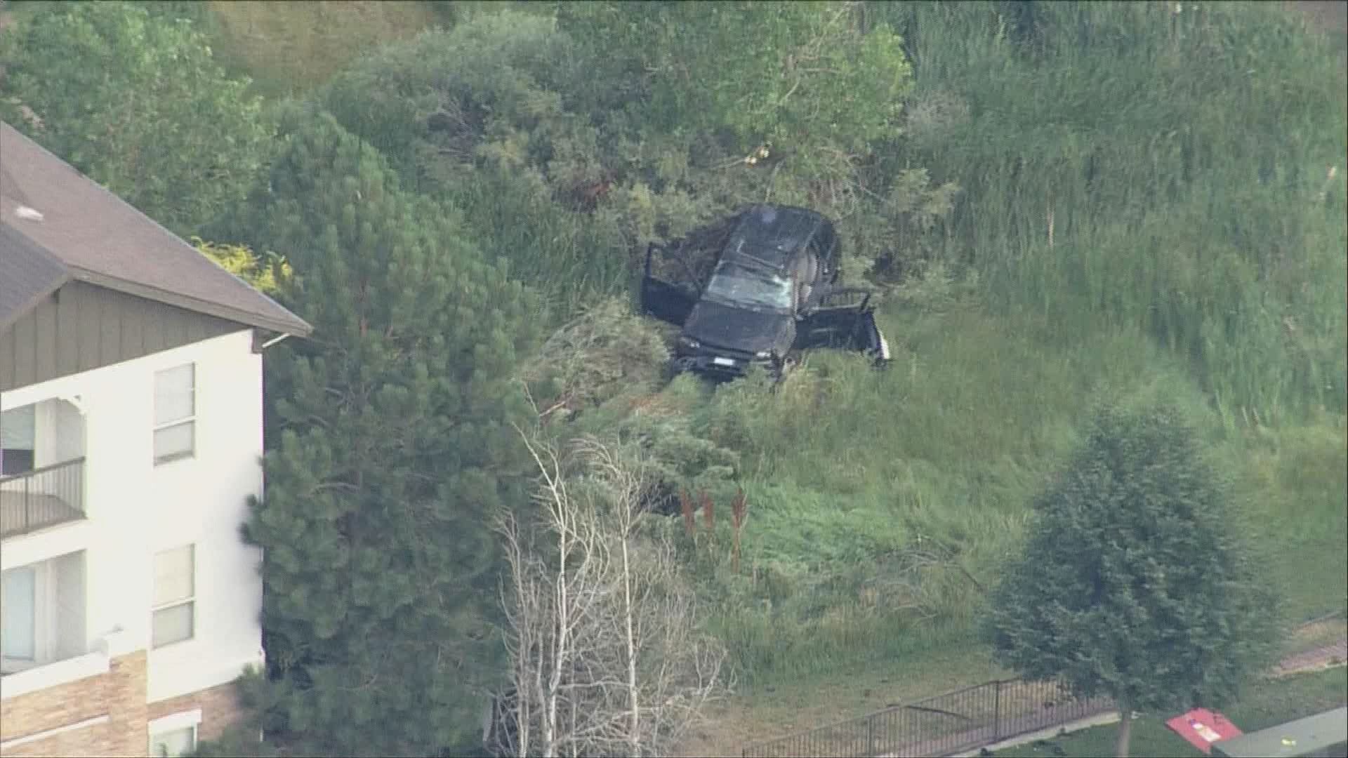 Crews work to tow a car off the road near Sable Blvd. and 4th Ave. in Aurora, Colorado.