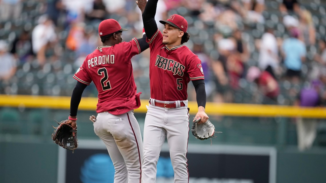 Walker hits three doubles as Rockies open Coors Field