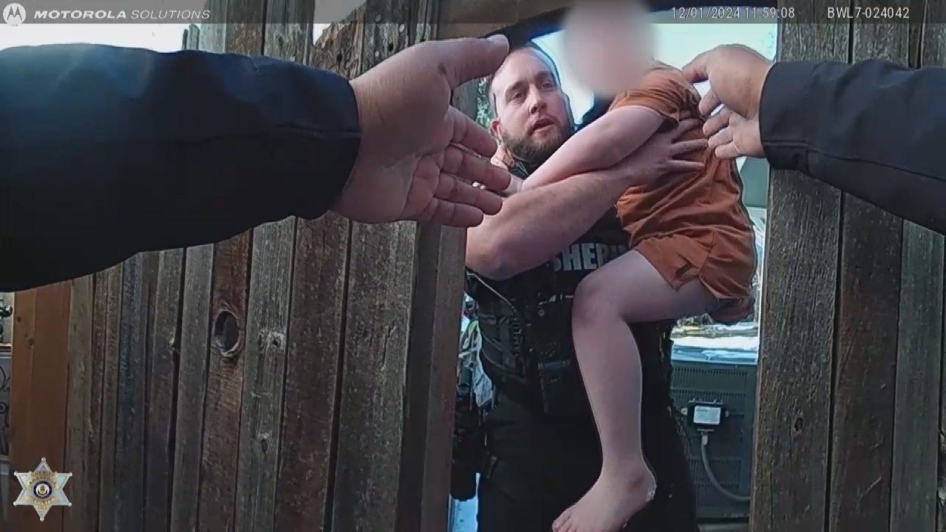 Dramatic body camera footage captured the rescue of two children from the backyard of a home that caught fire Sunday.