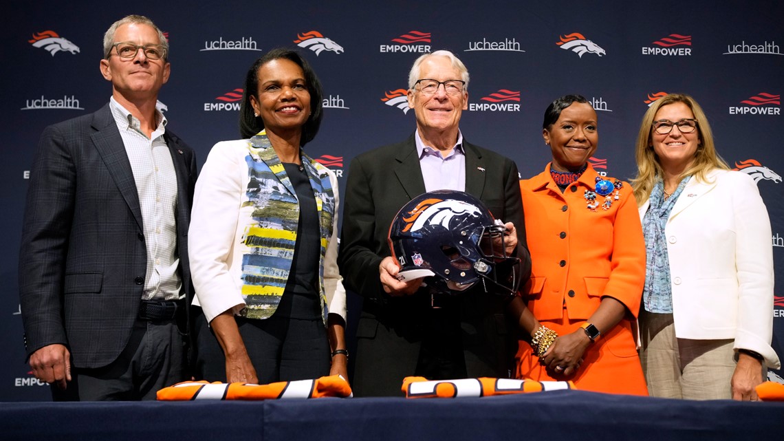 From left to right, Damani Leech, the new president of the Denver Broncos,  joins his daughters, Brianna and Simone, and wife Tamara for a photo after  an introductory news conference at the