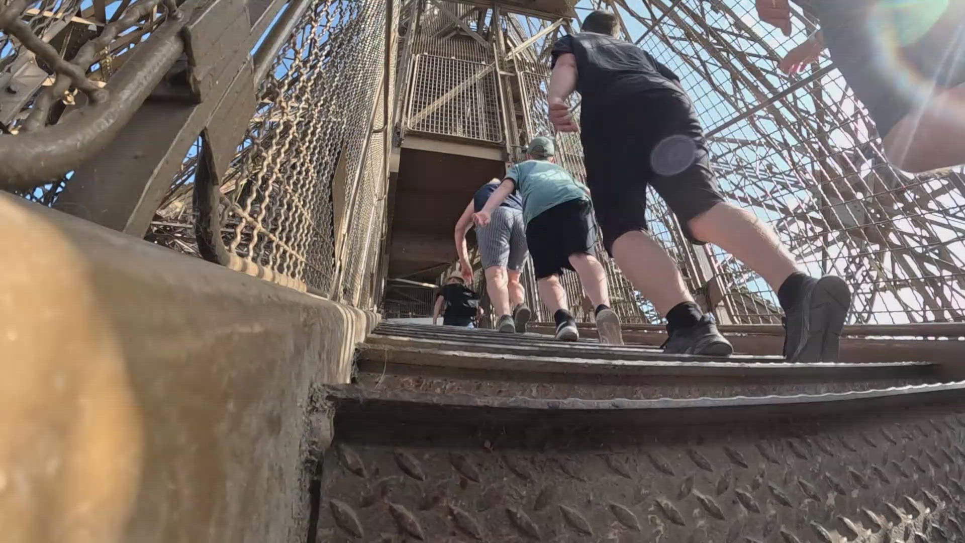 People climb hundreds of stairs to get to the second floor of the Eiffel Tower instead of taking one of five elevators.