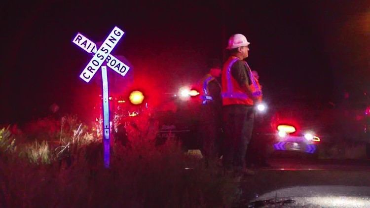 Woman in police vehicle hit by train expected to survive
