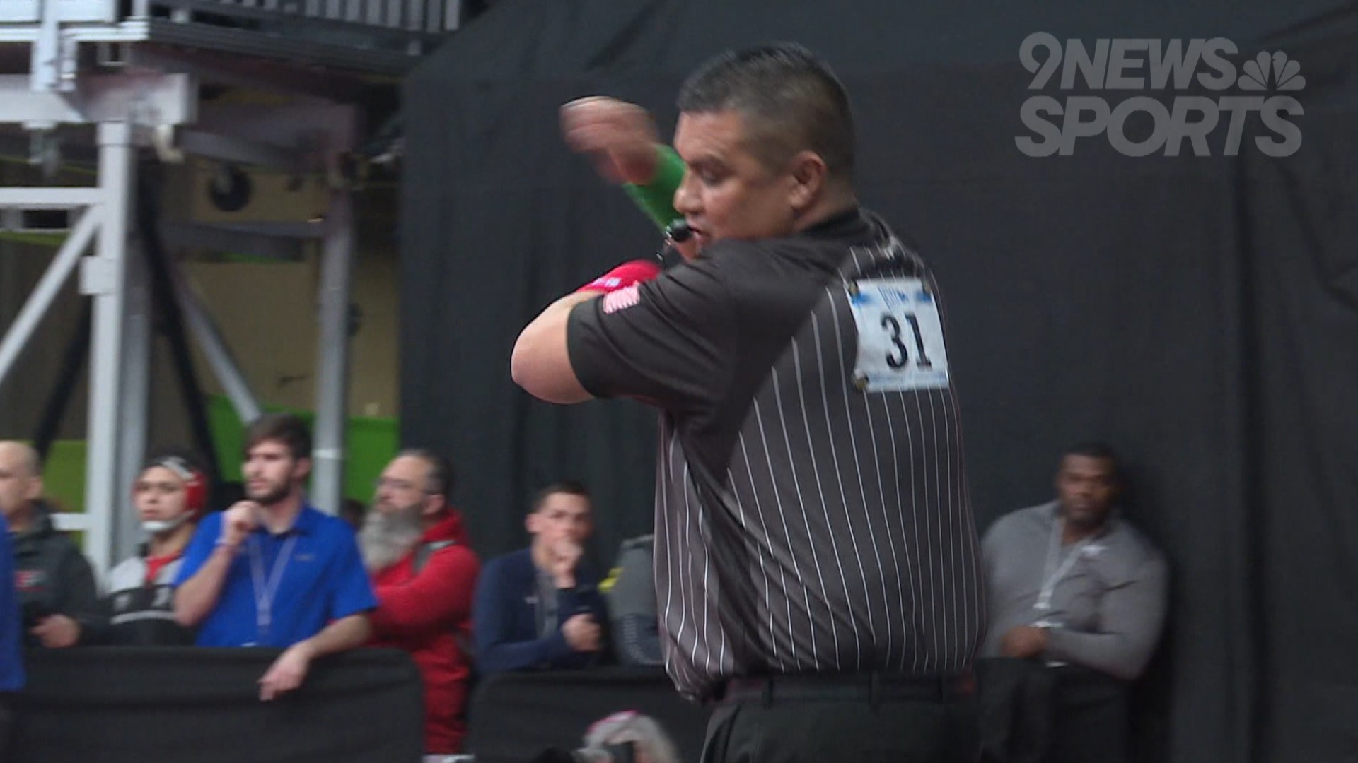 Referees at the Colorado wrestling state championships showcase impressive moves.