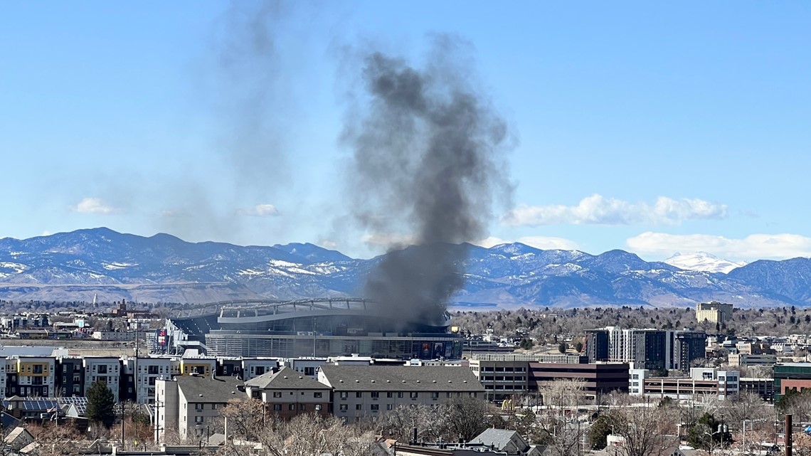 Denver Broncos stadium Empower Field at Mile High on fire as dark clouds of  smoke billow from building