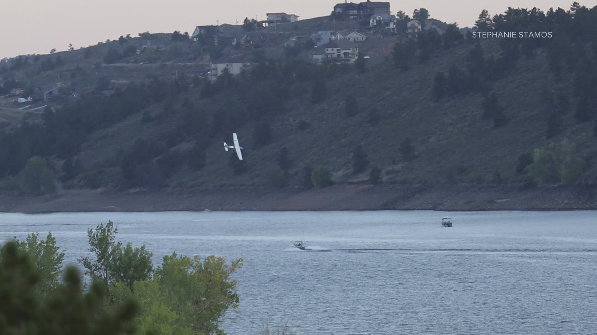 Photos show the small plane flying low over a boat at Horsetooth Reservoir prior to the Sept. 11 crash.