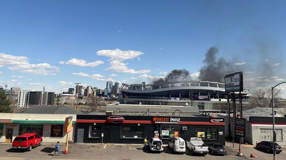 Denver Broncos stadium Empower Field at Mile High on fire as dark clouds of  smoke billow from building