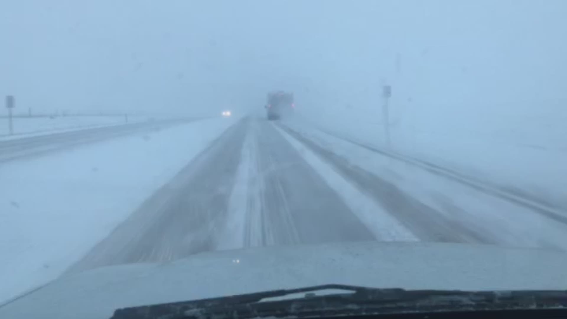 Areas north and east of Denver were under a snow squall warning Wednesday evening. Here's what conditions looked like.