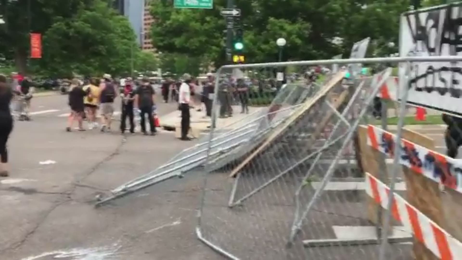 Protesters built a barricade from a chain link fence and road closure signs at 14th and Lincoln during the George Floyd protests on Saturday in Denver.