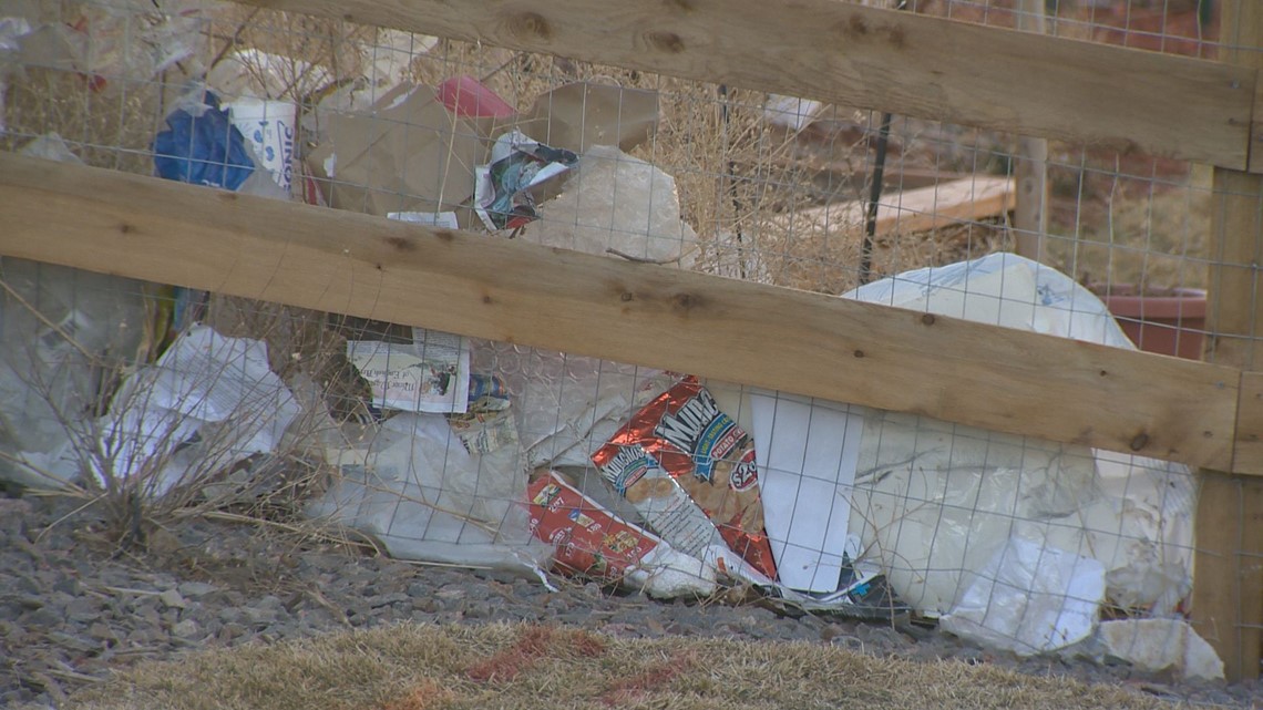 PHOTOS Residents believe trash from a nearby landfill is blowing into