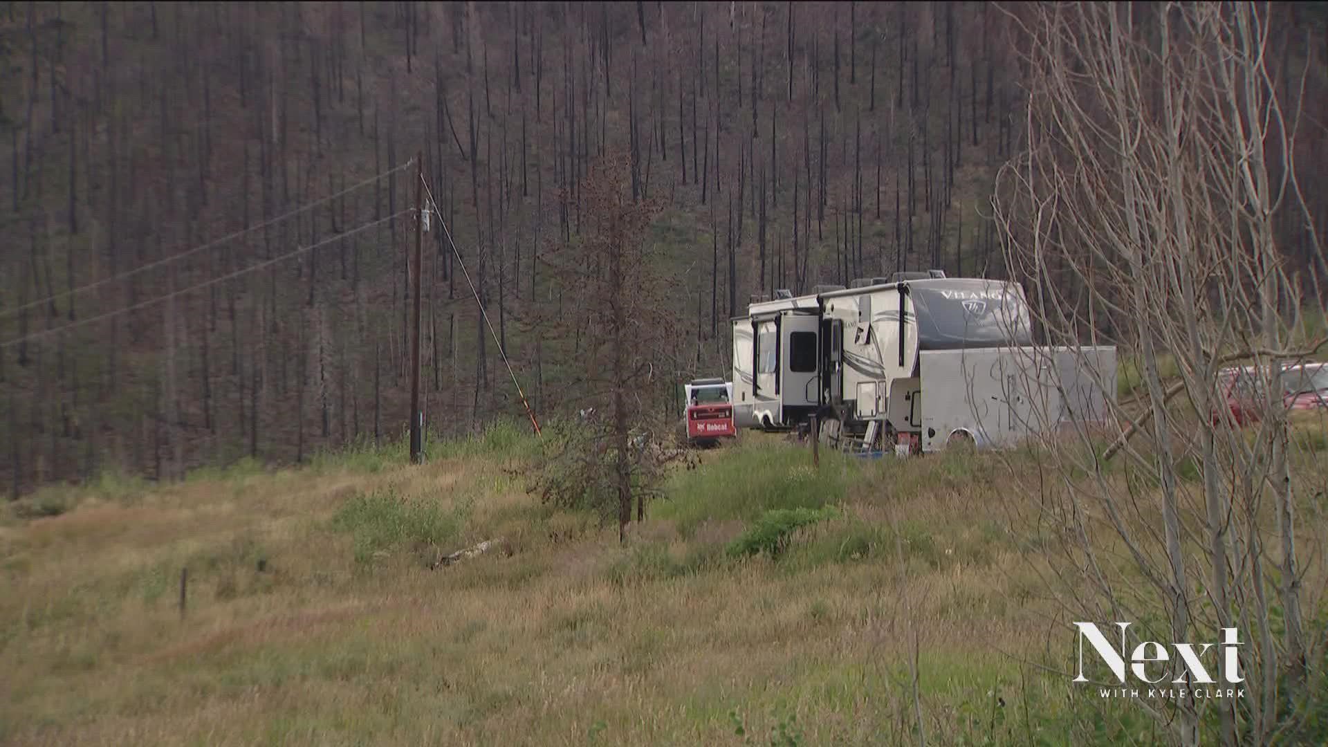 One woman is living in an RV on her burnt plot because there aren't enough builders for the recovery efforts.