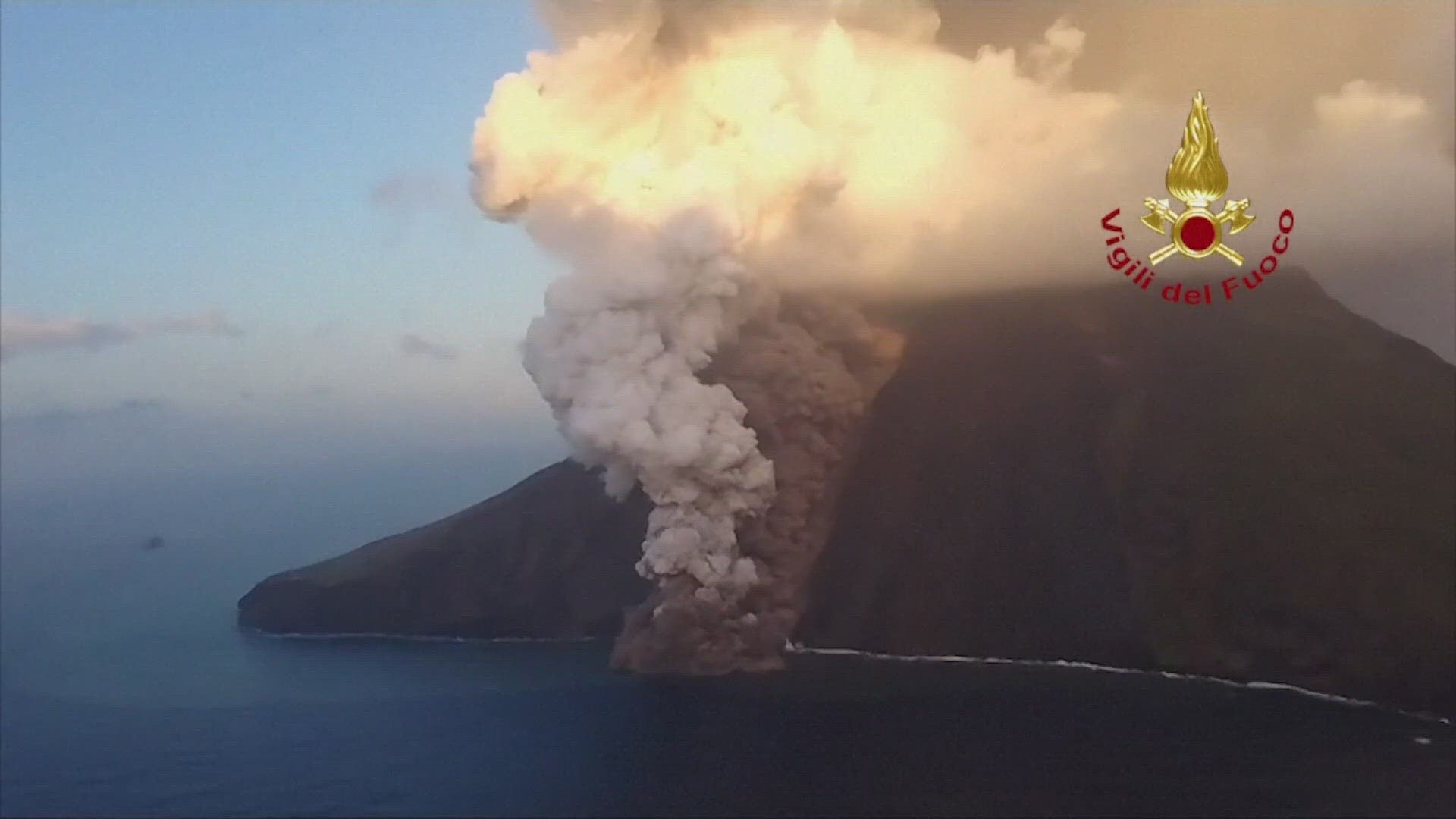 New video shows the volcano spewing smoke and ash while lava flows into the Mediterranean Sea.