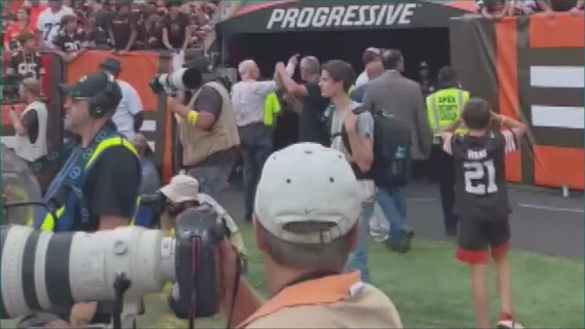 A Cleveland Browns fan has been banned from the stadium and arrested after throwing a bottle at owner Jimmy Haslam.