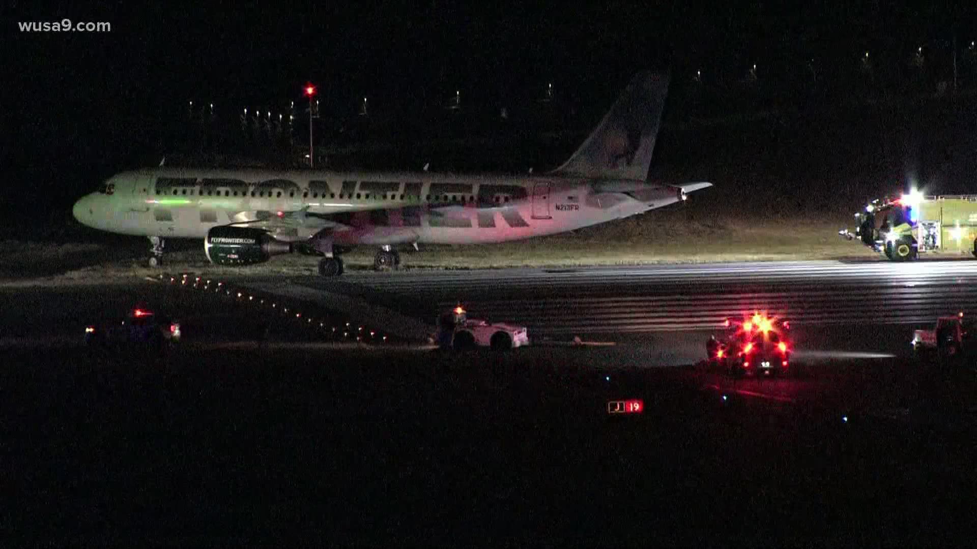 A Frontier Airlines plane has slid off the end of the runway at Ronald Reagan Washington National Airport Friday evening, officials say.