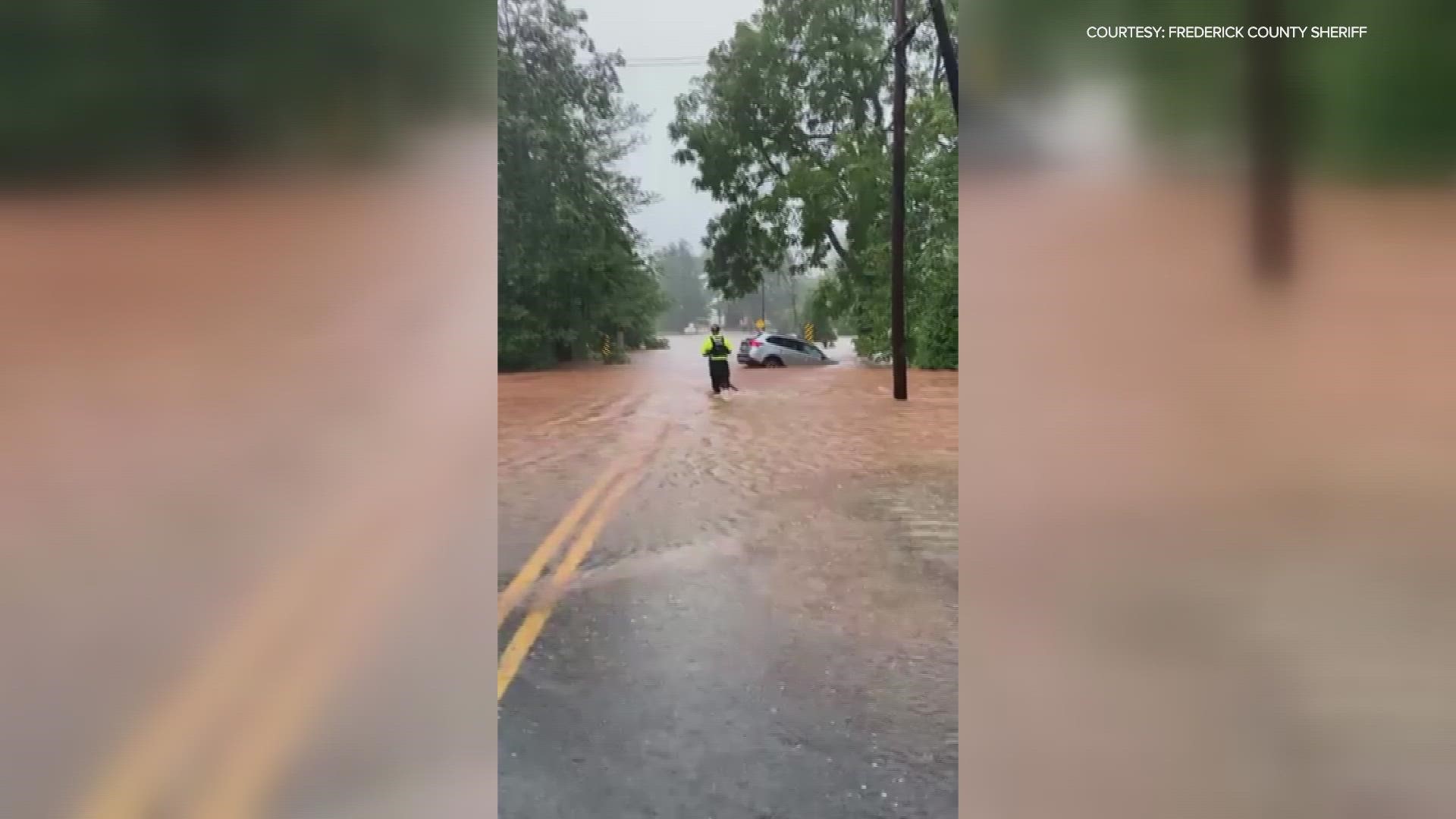 Crews rescues woman who drove into flooded road in Maryland.